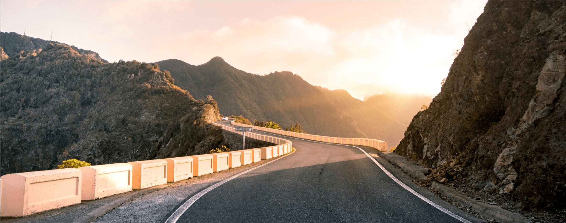 A road in the mountains at the sunset