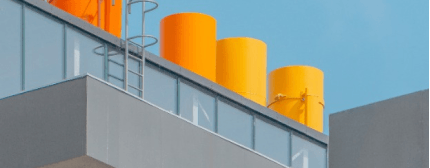 The roof of the building with yellow barrels